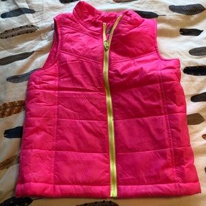 Hot pink puffer vest with neon yellow zipper